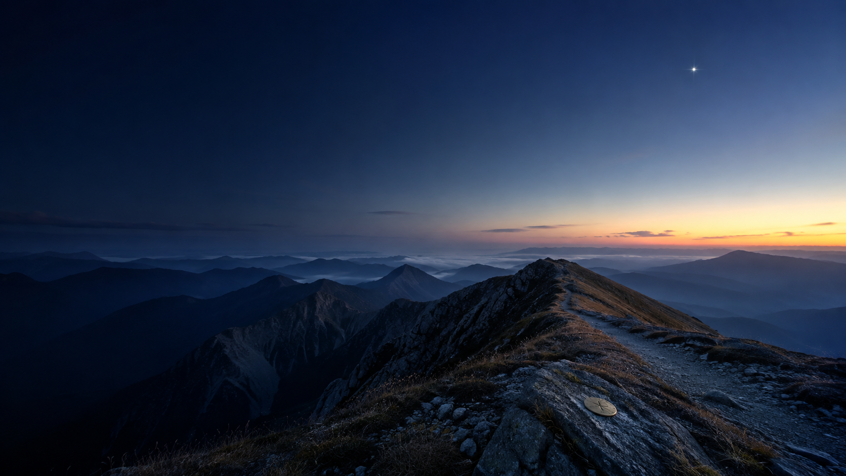 A mountain trail follows a blue ridgeline toward the first light of dawn beneath a guiding star.
